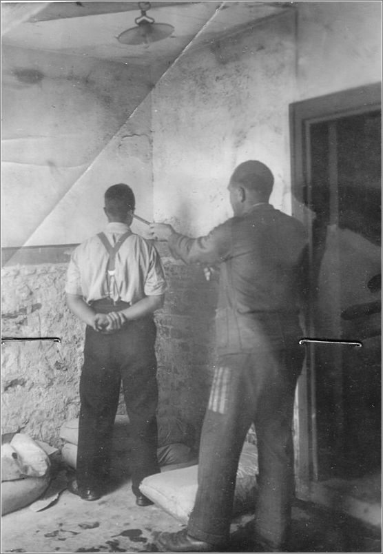 A Mauthausen block leader punishes an inmate